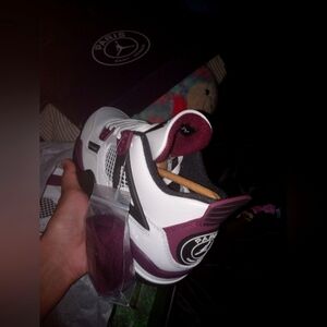 Jordan 4s size 6.5 and color is black and purple and white